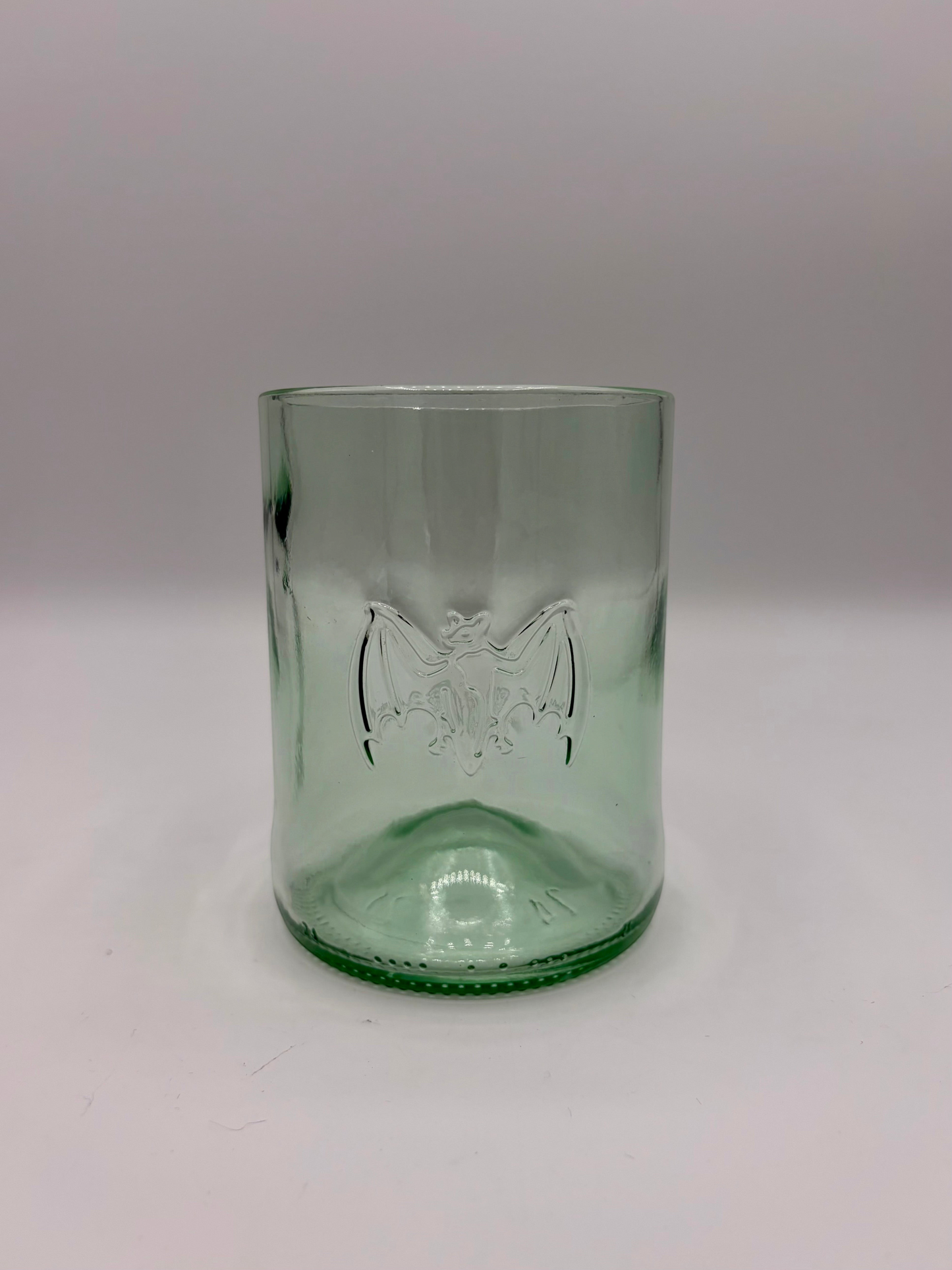 Broken Arrow Glass Recycling upcycled Bacardi bottle tumbler in sea glass green with embossed bat logo.