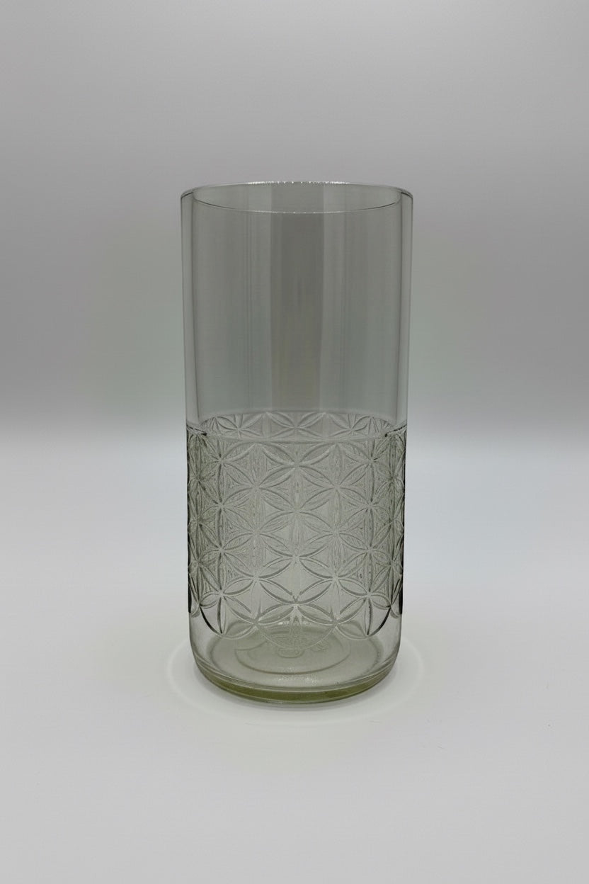 Broken Arrow Glass Recycling tall clear upcycled tumbler with an embossed flower of life geometric pattern.